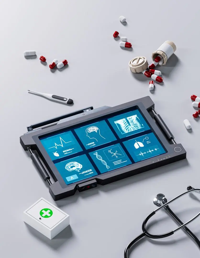 A medical tablet showing scans, with pills and a stethoscope around it.